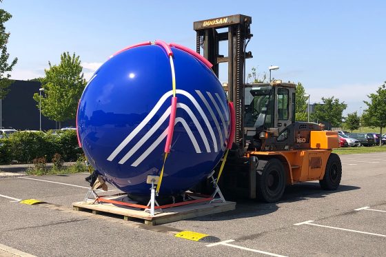 Forklift moving large industrial pressure vessel during AVTrade site installation